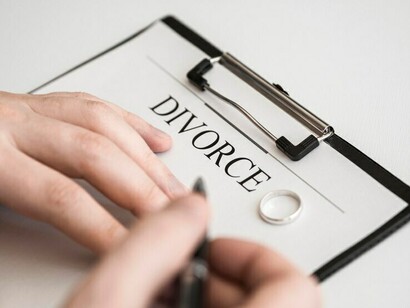 A man sits alone, staring at the divorce papers, struggling with the weight of his decision