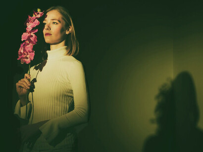 A pensive woman with a bouquet of fresh flowers