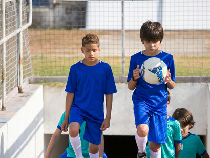 Young players in Portugal heading up the stadium steps on their way to a football academy training session