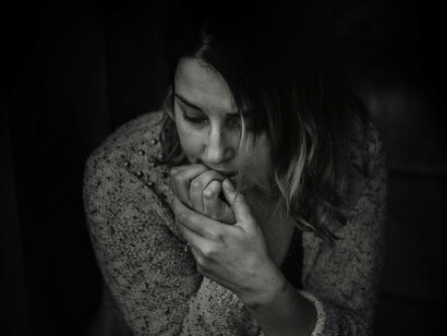 A woman biting her nails, a way how anxiety manifests itself