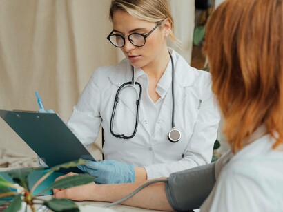 A doctor checks the patient's vitals before carrying on with the procedure
