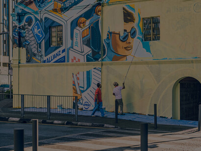 Man creating graffiti on a street in Kuala Lumpur, Malaysia