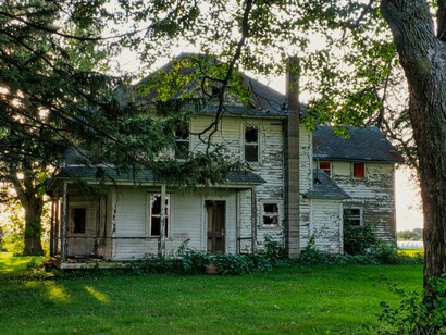 A weathered house standing resilient despite the passing decades, representing how memory still survives through changing times
