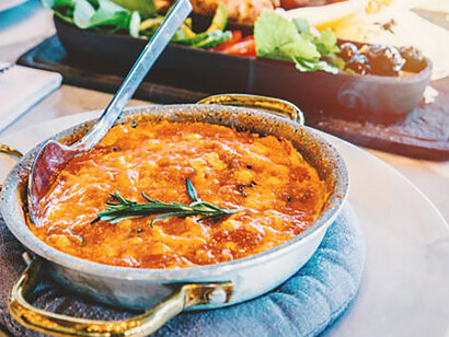 An exquisite representation of Turkish cuisine graces the table, with a steaming plate of menemen taking center stage