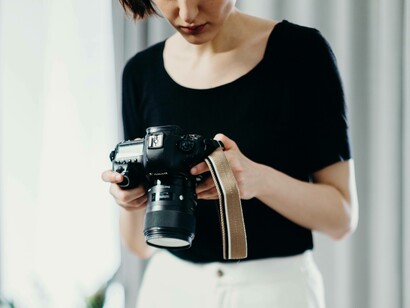 A woman taking a look at the creative images she took