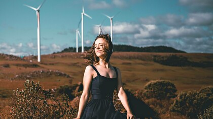 A woman posing by windmills