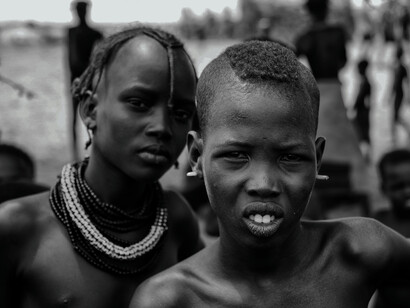 Captured in a moment of stillness, these Kisii boys' direct stare highlights the depth and seriousness with which they regard their cultural heritage