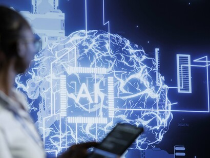 Backlit by a virtual brain and circuitry, a woman's focus highlights that understanding AI begins with hands-on learning and shared problem-solving