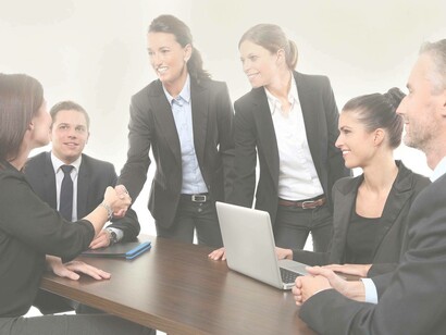 Baby boomers staffing Millennials in a friendly and jovial meeting with the intent to see if they are capable of taking the company further