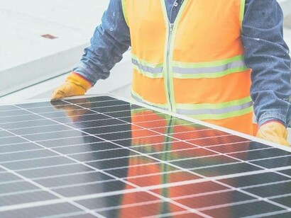 A man installing solar panels which were a result of linear innovation 