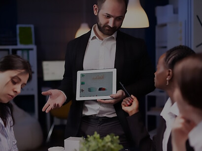 Witness a dynamic business presentation in an office setting, where a confident employee showcases growing sales statistics on a big TV screen, highlighting the essence of fashion data analysis and customer insights