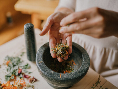 Vibrant herbs are ground into a paste, showcasing the power of time-tested South Asian botanical remedies
