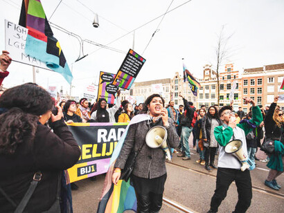 An anti-racist parade in Amsterdam, Netherlands, exemplifies human rights activism, highlighting the role of civil society organizations in advocating for social justice and challenging power dynamics related to human rights