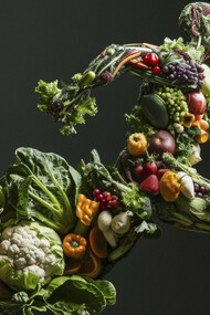 A running figure composed entirely of colorful fruits and vegetables symbolizing the vital connection between healthy eating and athletic performance