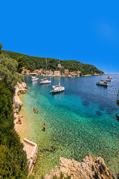 The charming harbor of Kioni Village on Ithaca Island, Greece, is known for its crystal-blue waters, colorful boats, and traditional Ionian architecture