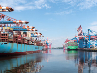 Container ship being loaded by industrial cranes at Hamburg’s busy port in Germany