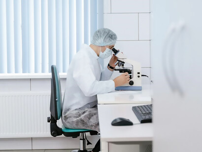 In a laboratory suffused with brightness, a scientist, attired in a pristine white lab coat, meticulously conducts experiments within the confines of a sterile and luminous workspace
