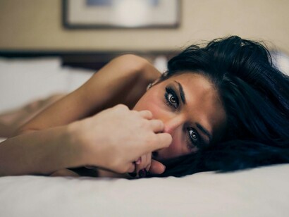 Chica tendida en su cama