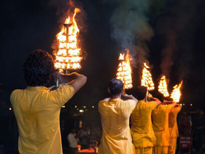 As the sun sets, the sacred melodies of the Ganga Aarti fill the air on the banks of the Ganges in Varanasi, India