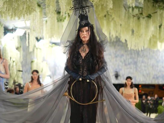 Madonna in custom Saint Laurent by Anthony Vaccarello, wearing a dramatic black lace ensemble with a sculptural ship-inspired headpiece and flowing veil during the 2026 Met Gala
