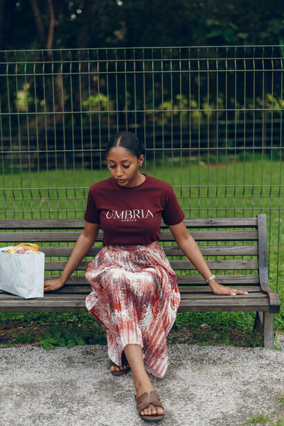 A young woman resting quietly on a bench in the park