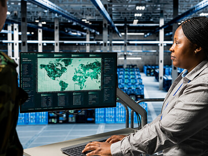 Military personnel analyzing target coordinates in a high-tech command and control center