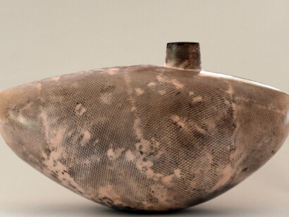 Alison Kay: Wide Pale Coral Vessel with Off Centre Opening, 2016. Ceramic. 9” x 16” x 7”. Courtesy of J. Cacciola Gallery W and the artist. 
