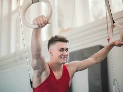 Determined and resilient, a young gymnast prepares between horizontal bars, symbolizing persistence and strength