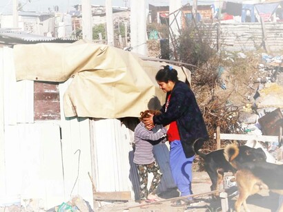 A woman and her daughter stand outside their shack in a slum of Villa Fiorito, on the outskirts of Buenos Aires, Argentina, South America