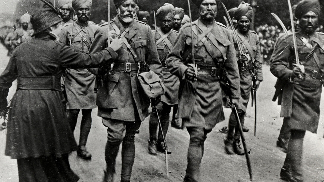 Stalwarts from the East, A French lady pins a flower on the Sikh saviours of France, Paris, 1916. (Source: Toor Collection)