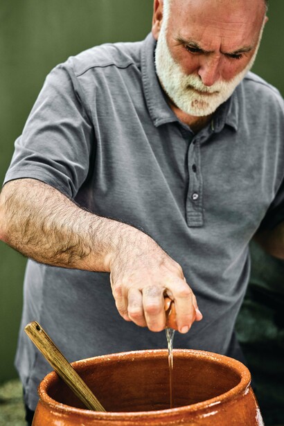 Chef José Andrés making a tasty dish by cracking an egg into it. Photography by Joan Pujol-Creus