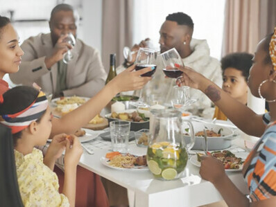 The entire family gathers around the dinner table, sharing a meal together and enjoying each other's company