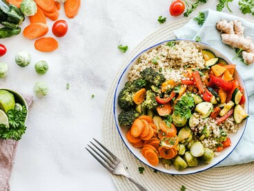 A nutrient-rich meal bursting with fresh produce, symbolizing how a balanced diet helps nourish hair from within