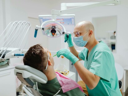 A dental examination in progress, highlighting the contrast between advanced healthcare systems in developed nations and limited access elsewher
