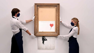 Gallery employees pose with Love is in the Bin by Banksy, photo by Facundo Arrizabalaga/EPA