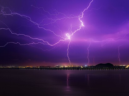 The branches of lightning visible as it strikes, reflecting the need to ensure that the infrastructure is safe and can withstand extreme weather