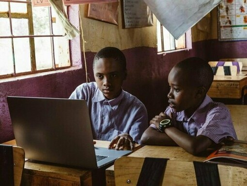 Students taking advantage of technology, reflecting the role of digital tools in redefining opportunity across the region
