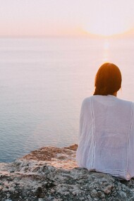 Woman contemplating the sea, looking into herself