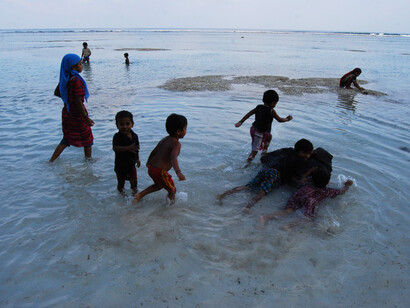 Children in the sea, Lakshadweep Islands (India) - we readily accept that they are playing, so why not with other animals?