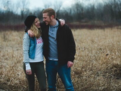 Two people in a wheat field 