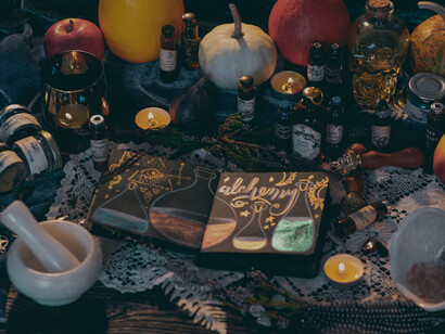 Vials, teacups, books, and candles arranged to signify mythical realms