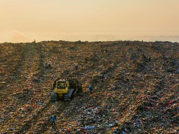 A growing mound of discarded resources, presenting the cost of neglecting reuse and preservation