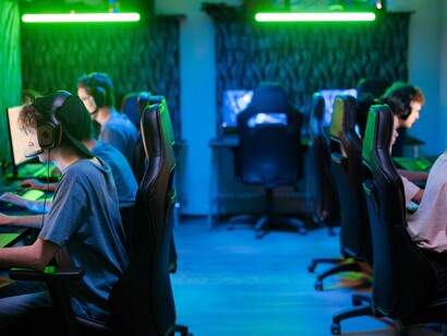 People gaming on computers in a 2000s internet café.
