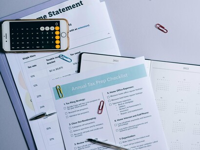 An arrangement of tax papers and computation tools, reflecting the complexity of the taxation system