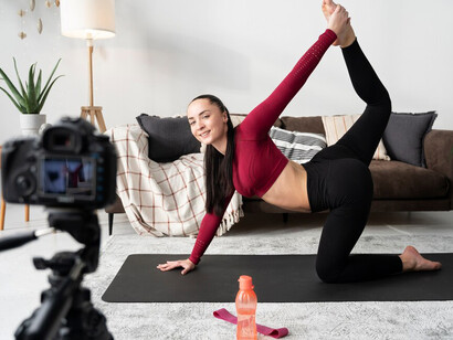 As social media mysticism grows, an online fitness instructor records a session, reflecting the influence of virtual healing, digital spirituality, and modern-day online guru