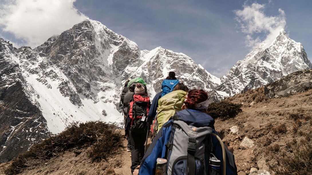 People working together to climb a mountain