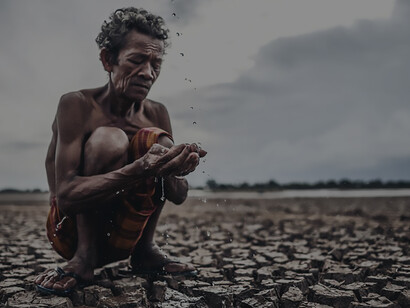 In the midst of a severe drought and water scarcity, an elderly man is seen fervently praying for rain during the dry season