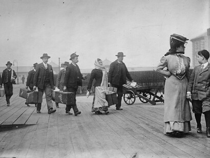 Immigrati che trasportano bagagli, Ellis Island, New York, USA