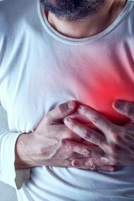 A man clutching his heart which is carrying a disease