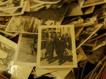 Vintage suitcase filled with old photographs